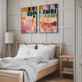 Colorful poster pair shown in slim frames with pink navy teal and mustard tones