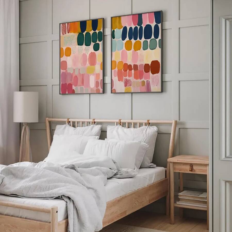 Colorful poster pair shown in slim frames with pink navy teal and mustard tones