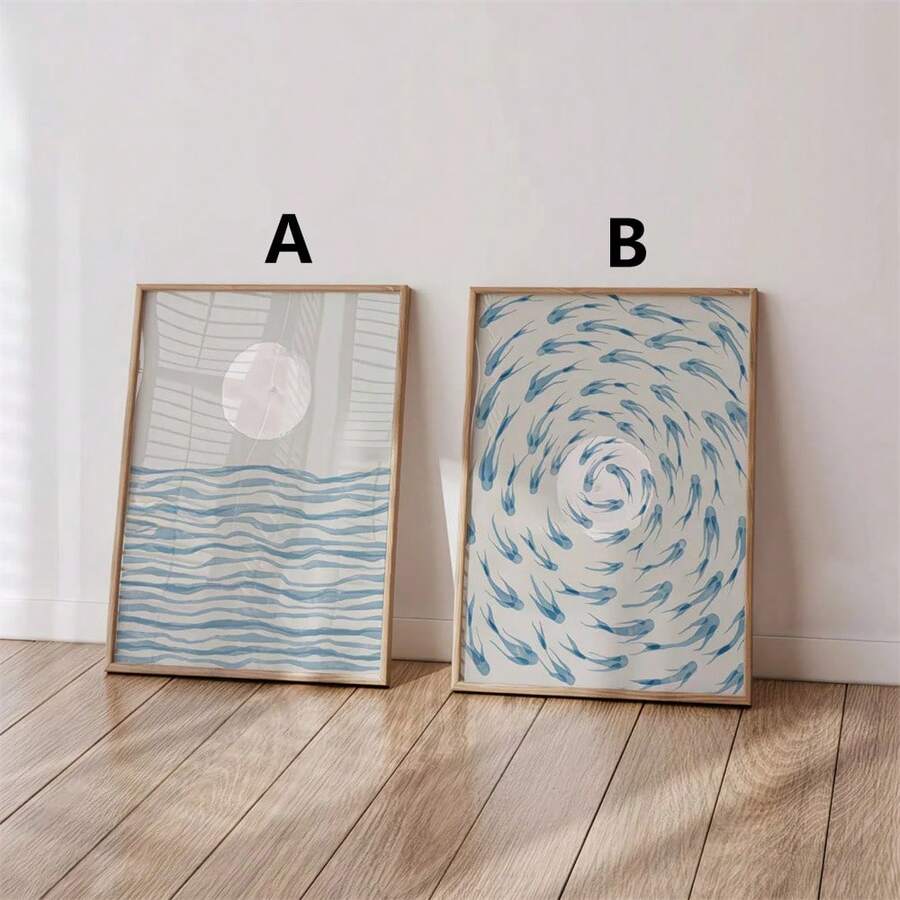 Framed coastal wall art set with blue wave print and blue fish swirl print above white chair