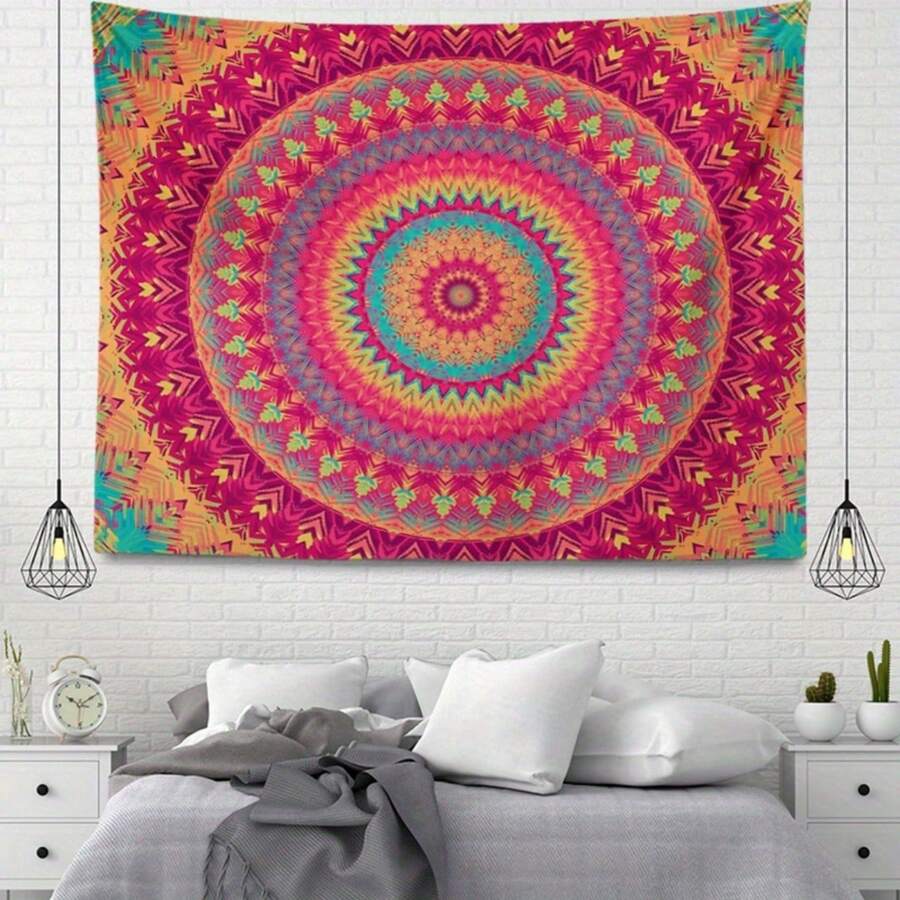 Rectangular bohemian mandala tapestry hanging above bed with bright pink orange and teal pattern