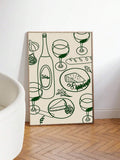 Framed cream and dark green food and wine wall art leaning against wall