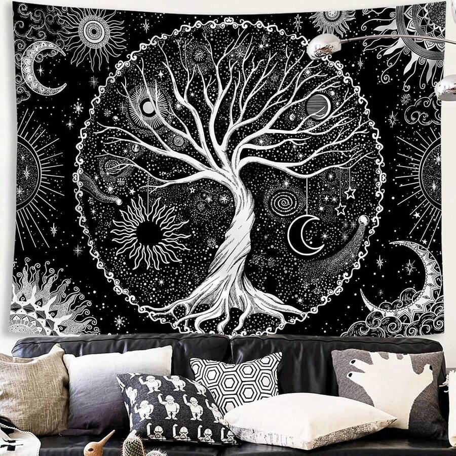 Black and white sun and moon tree tapestry displayed above sofa