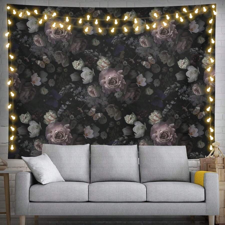 Dark vintage floral tapestry displayed above white sofa in living room