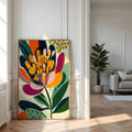 Large framed bohemian floral canvas print leaning on a living room floor