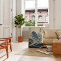 Vintage blue octopus wave poster in a wood frame in a sunlit living room