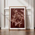Abstract shadow leaf wall art in a black frame with a white mat