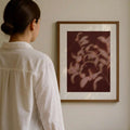Burgundy botanical canvas print in a natural wood frame for a warm interior