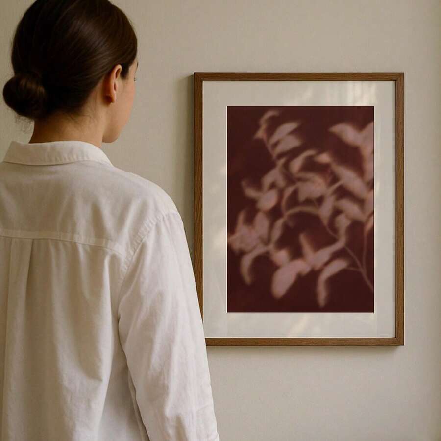 Burgundy botanical canvas print in a natural wood frame for a warm interior