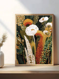 Framed botanical wall art with white flowers orange stems and green foliage on shelf