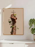 Framed hand and cross wall art mounted above a bright cabinet