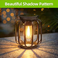 Black solar hanging lantern with chain, S hook, amber shade, and filament LED.