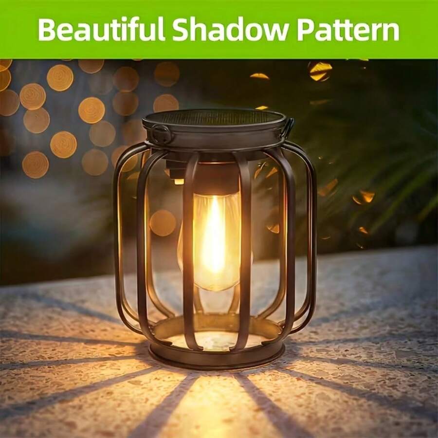 Black solar hanging lantern with chain, S hook, amber shade, and filament LED.
