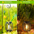 Outdoor LED garden lamp hanging from tree branch with warm glow.