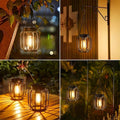 Solar hanging lantern on tabletop casting decorative shadow pattern.