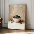 Oversized coffee bean still life poster leaning against paneled wall in warm room