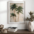 Framed tropical palm print on console table with vase and books