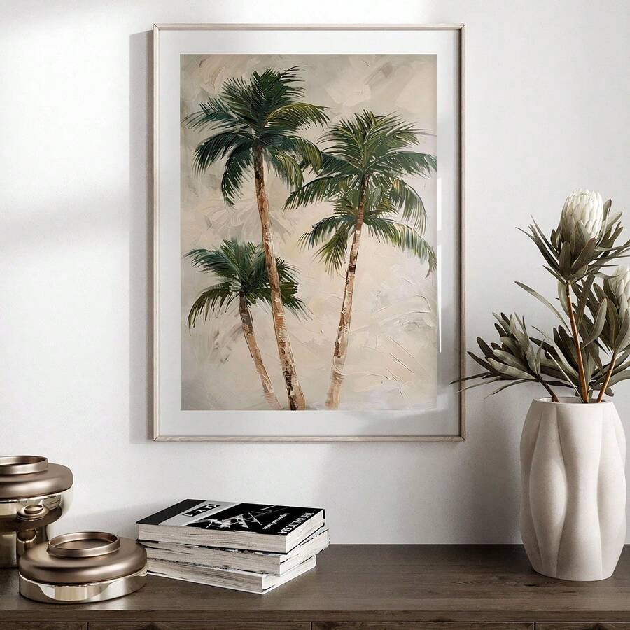 Framed tropical palm print on console table with vase and books
