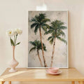 Palm tree framed print styled with vase and pink bowl on light wood table