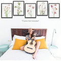 Five vintage wildflower prints above a bright bedroom and guitar