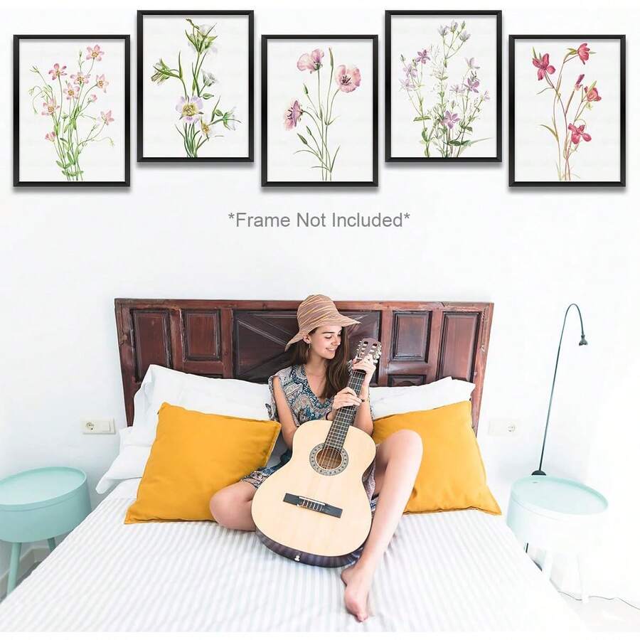 Five vintage wildflower prints above a bright bedroom and guitar