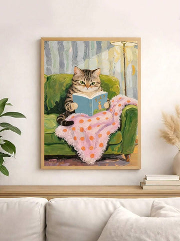 Framed tabby cat reading blue book on green armchair wall art