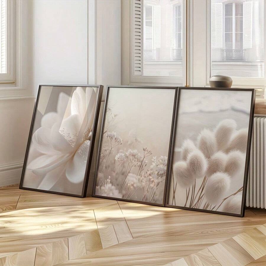 Neutral botanical triptych leaning in dark frames on the floor