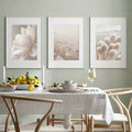 Neutral botanical three-piece artwork above a dining table
