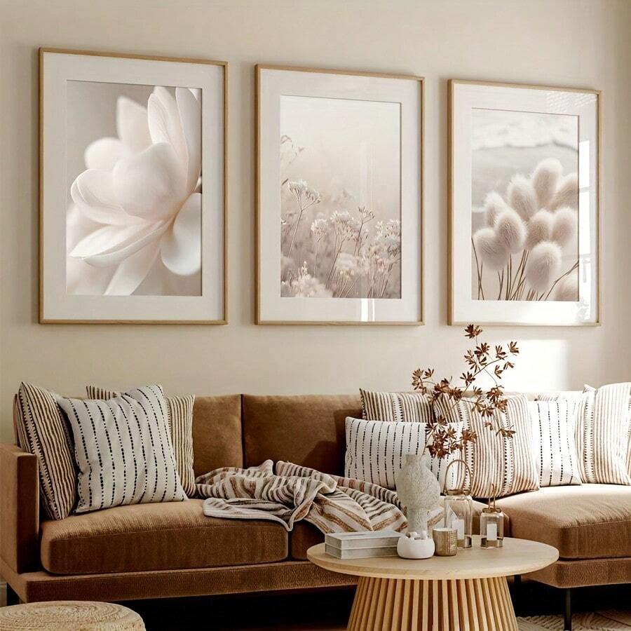 Botanical triptych in light wood frames above a brown sofa