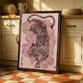Pink tiger and cloud swirl poster in a dark frame near kitchen cabinets