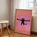 Pink cat love poster displayed beside a window and wood stool