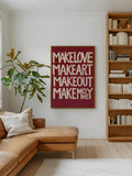 Burgundy typography poster in living room with make love make art message