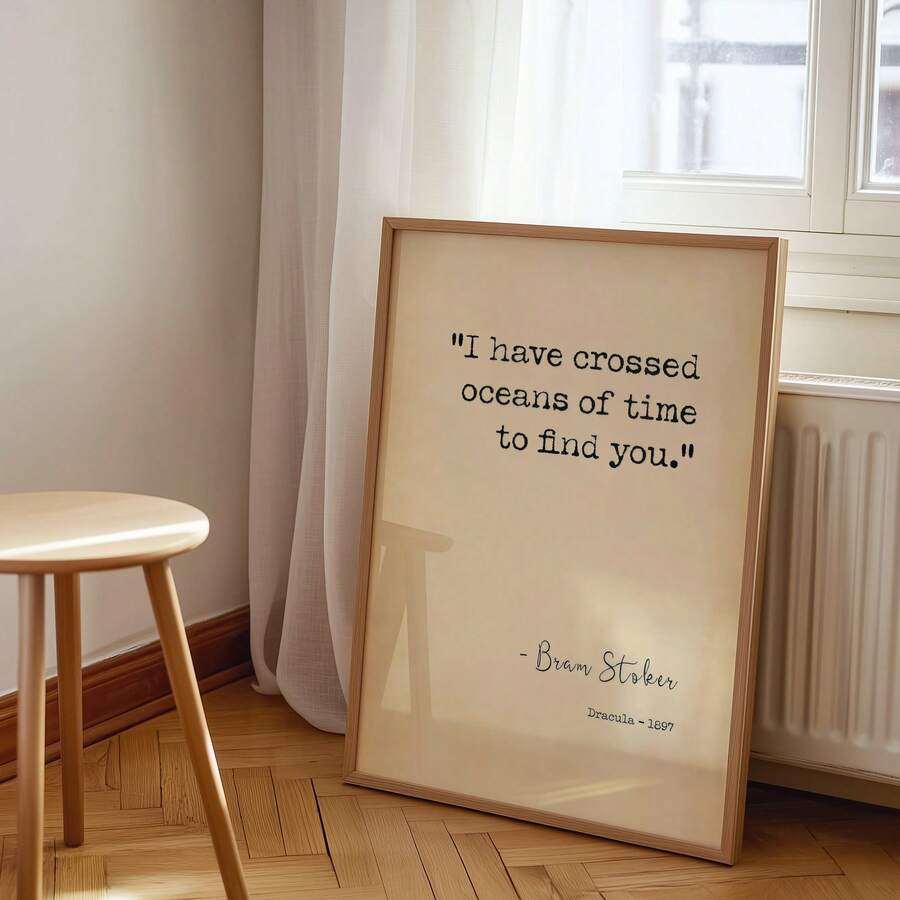 Framed gothic romance quote poster leaning below window near radiator
