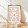 Retro daisy print in natural wood frame on sunlit floor
