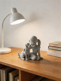 Nordic girl and dog sculpture in speckled off-white stone-look finish.