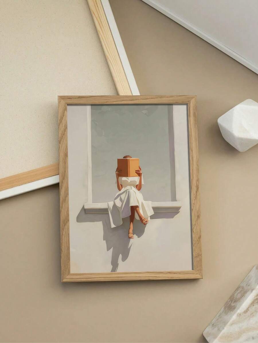 Framed neutral wall art of woman reading orange book on window ledge above vintage console