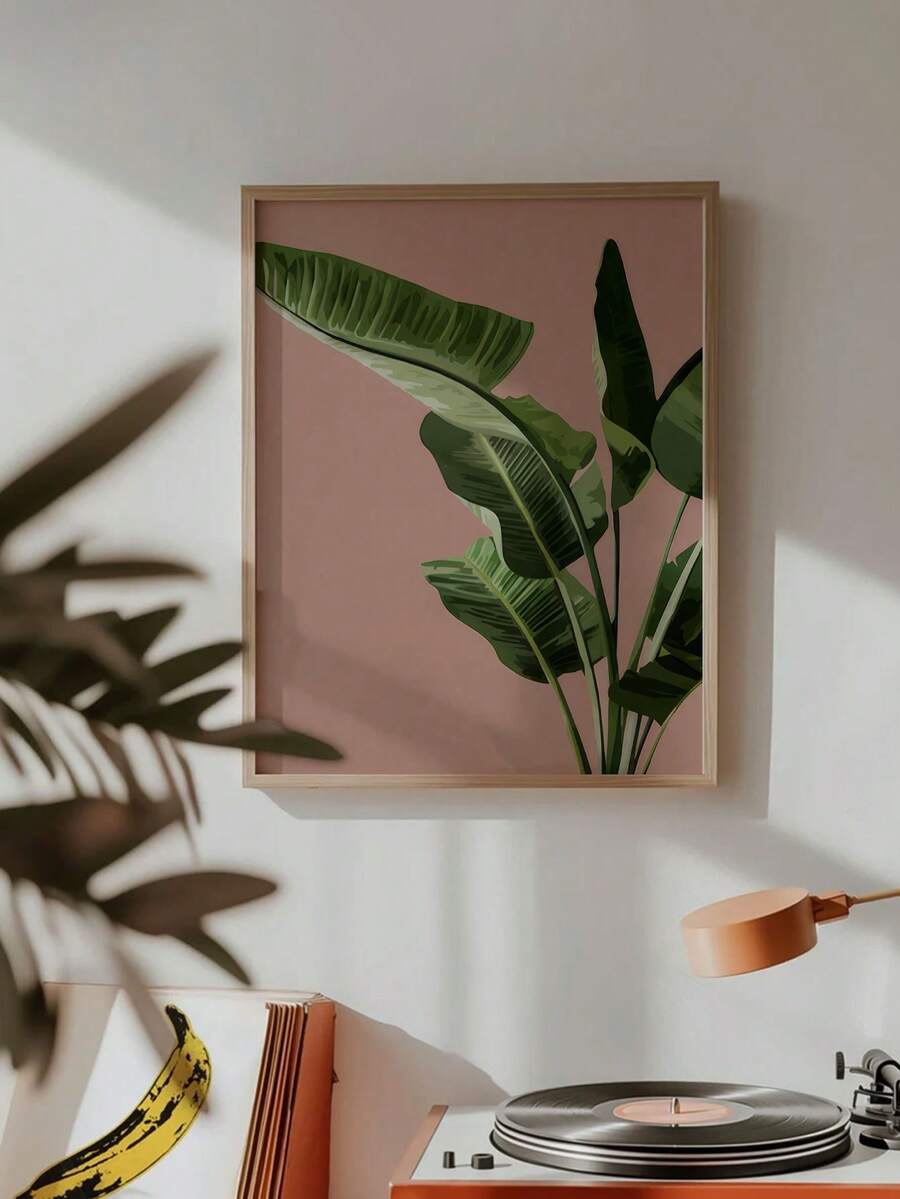 Pink and green tropical leaf wall art in a retro music corner