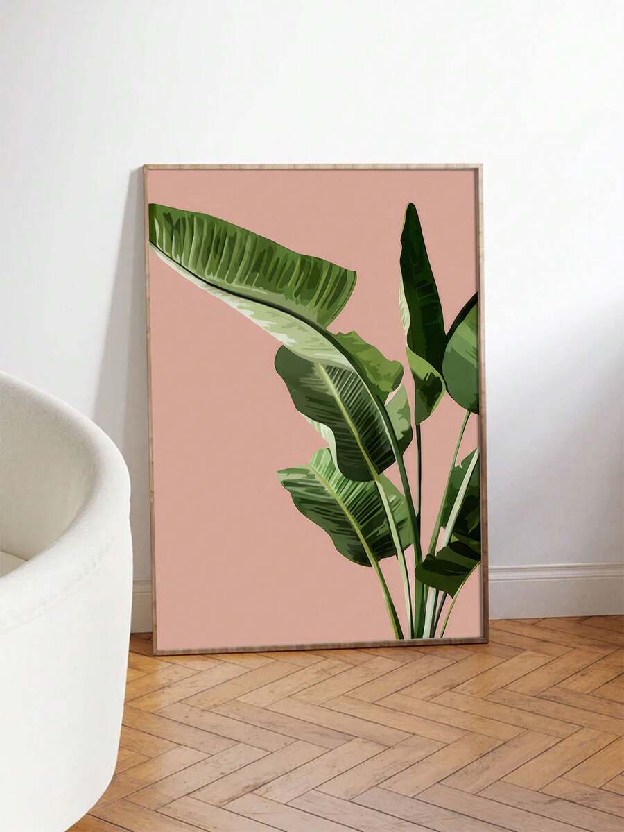 Oversized pink tropical leaf poster leaning beside a white chair