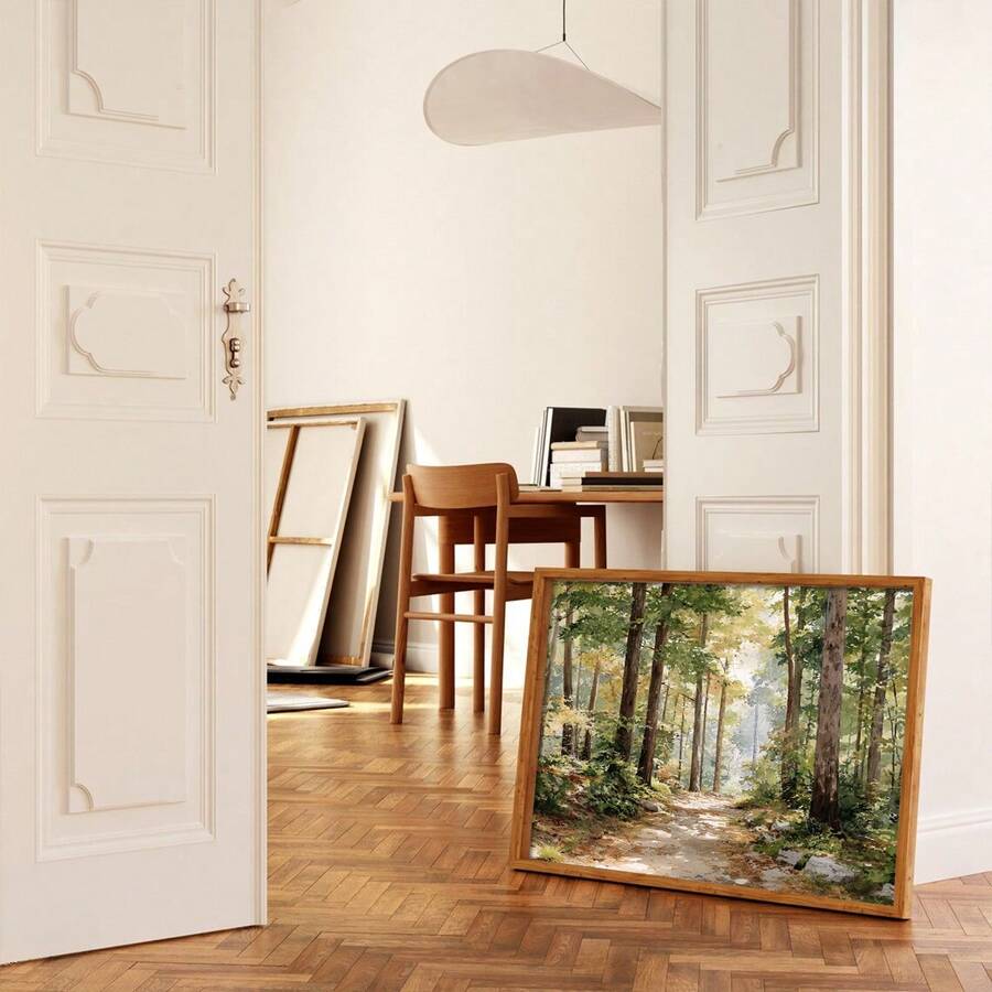 front framed view of Framed canvas-style forest landscape wall art showing a sunlit woodland trail with green foliage, tall trees, soft gold light and rustic cottage mood.