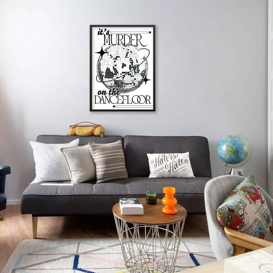 Black and white disco ball dancefloor poster hanging above gray sofa in living room