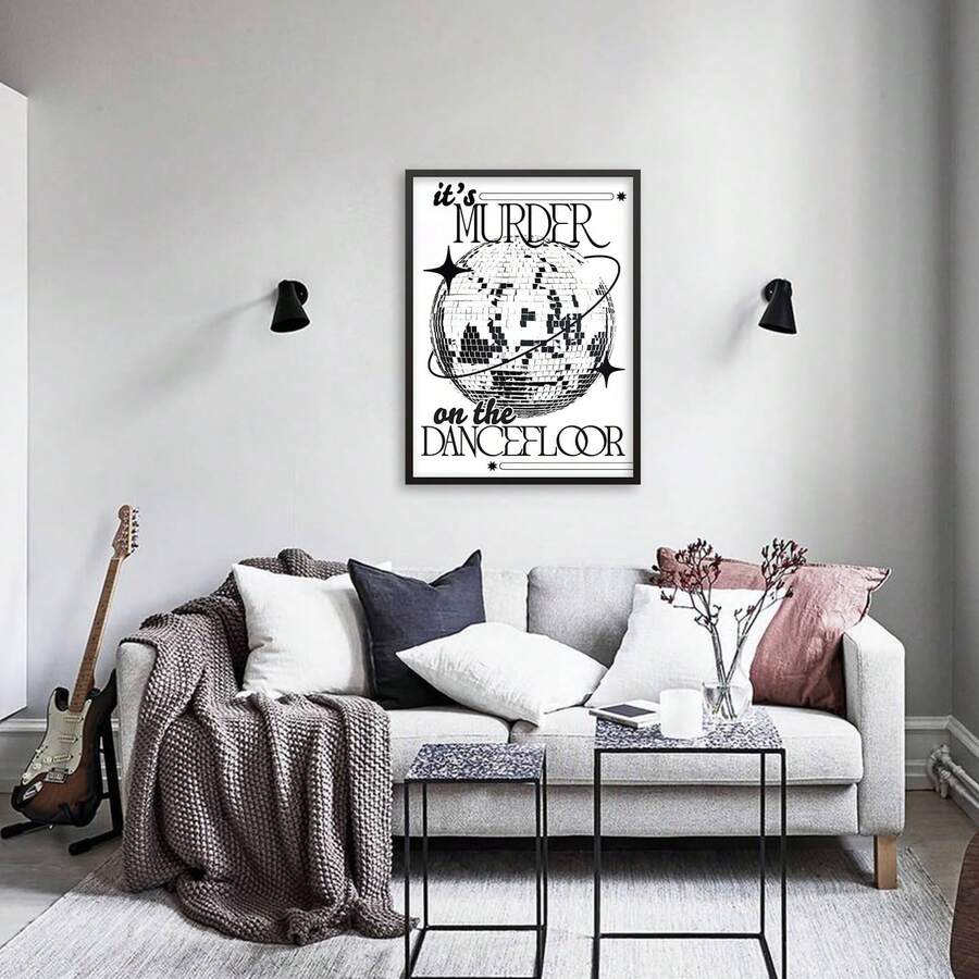 Black and white dancefloor poster above sofa with guitar nearby