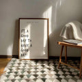 Framed note to self quote print leaning on patterned rug with sun shadows