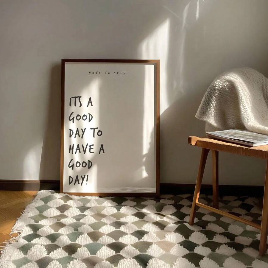 Framed note to self quote print leaning on patterned rug with sun shadows