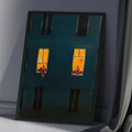 Modern canvas decor with dark teal city facade gold frame and cozy night atmosphere