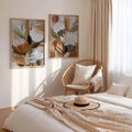 Abstract flower and plant canvas set framed above modern neutral bed