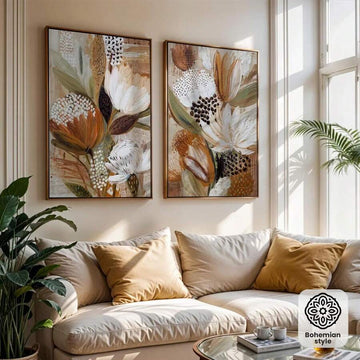 Framed abstract botanical canvas pair above neutral boho living room sofa