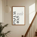 Minimalist Bible verse poster on staircase wall with warm sunlight