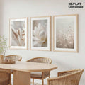 Botanical three-piece wall art displayed above a pale dining table
