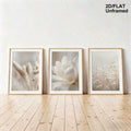 Neutral wildflower and foxtail print set leaning against a white wall