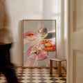 Large portrait donut and disco ball painting leaning on a cream room wall above a checkerboard floor