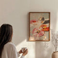 Portrait framed pink and orange donut painting with a mirrored disco ball on a sunlit wall